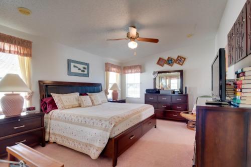 a bedroom with a bed and a ceiling fan at Lady Lake House with Lanai and Community Pool! in Lady Lake