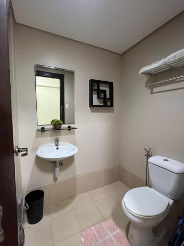 a bathroom with a toilet and a sink at Cozy Staycation at Eastbay Residences in Manila