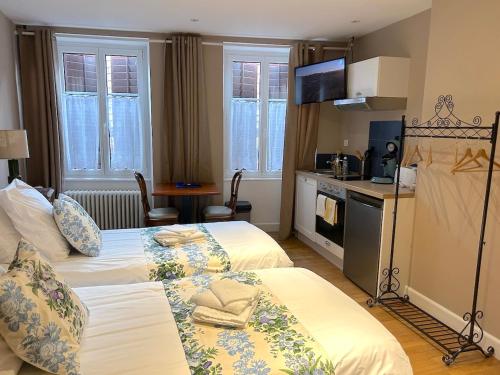 a hotel room with two beds and a kitchen at Hostellerie Alsacienne de Masevaux in Masevaux