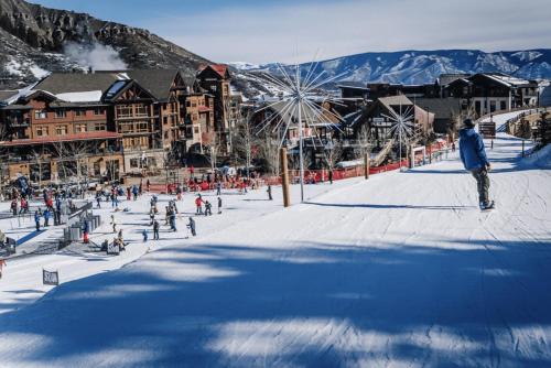 a group of people skiing on a ski slope at Mountain Sky Stay in Aspen