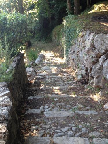 a stone path next to a stone wall at Medieval Village B&B in Ne