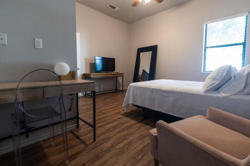 a bedroom with a bed and a desk with a mirror at Luxury Apartment Home in Mission