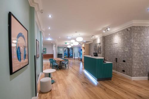 a large room with a table and chairs in a building at Garner Hotel Reading City Centre, an IHG Hotel in Reading