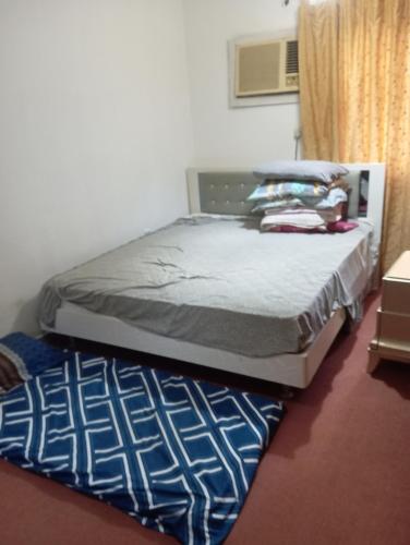a bed in a room with a mattress and a window at Your friendly home room in Sharjah