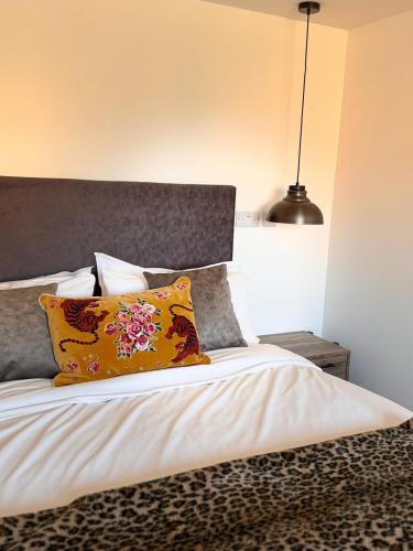 a bedroom with a bed with a pillow and a lamp at The Rewind Retreat in Sandwich