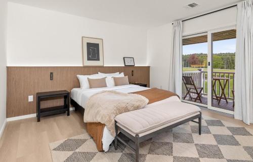 a bedroom with a large bed and a balcony at Pond House at Carter Bridge Estate in Freehold