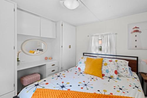 a bedroom with a bed with yellow pillows at Beautiful Decorated Cozy Retreat in Rockaway Beach