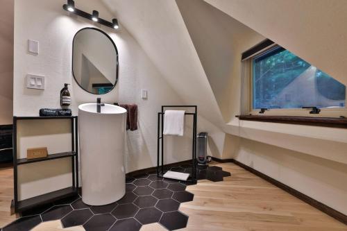 a bathroom with a sink and a mirror at Hidden Dome Retreat in the Trees in Barview