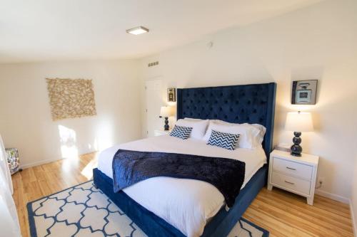 a bedroom with a large bed with a blue headboard at Crown Point Hideaway in Crown Point