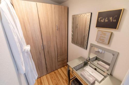 a small bathroom with a mirror and a sink at Crown Point Hideaway in Crown Point