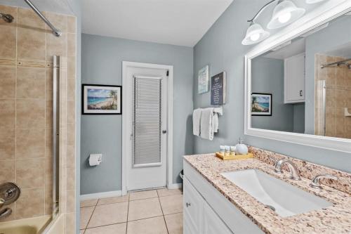 a bathroom with a sink and a shower and a mirror at Florida Flair Villa in Cape Coral Hospital Heliport