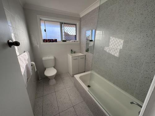 グラフトンにあるApartments on Turf Unit 4の浴槽、トイレ、洗面台を備えたバスルーム