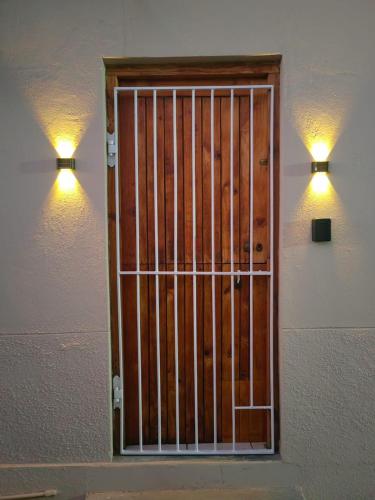 a door with a metal gate on a wall at WegkruiperQ in Beaufort West