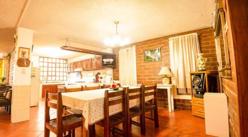 a kitchen with a table and chairs in a room at Casa del Huesped in Otavalo