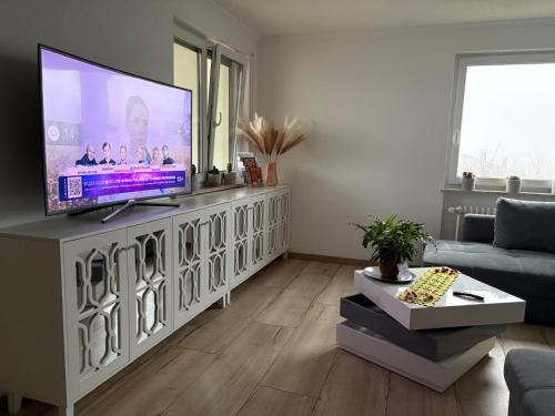 a living room with a flat screen tv on a entertainment center at Apartment O&V 2 in Waldshut-Tiengen