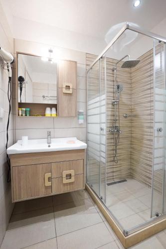 a bathroom with a sink and a shower at Ipsos Wave Apartments in Ipsos