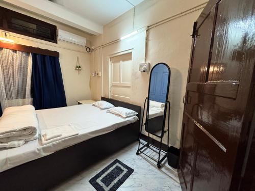 a small room with two beds and a chair at Varnas Cosy Stay in Guwahati