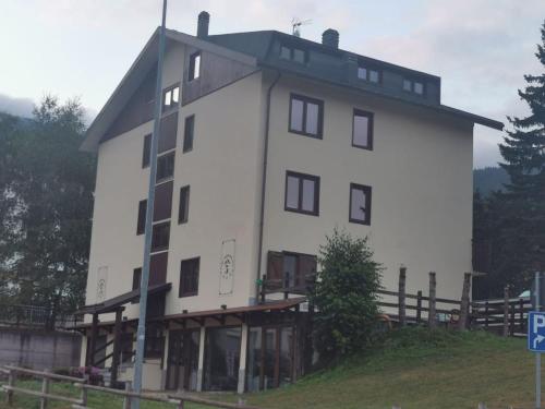 a large white building on top of a hill at Hotel Genevris Cinq in Sauze d'Oulx