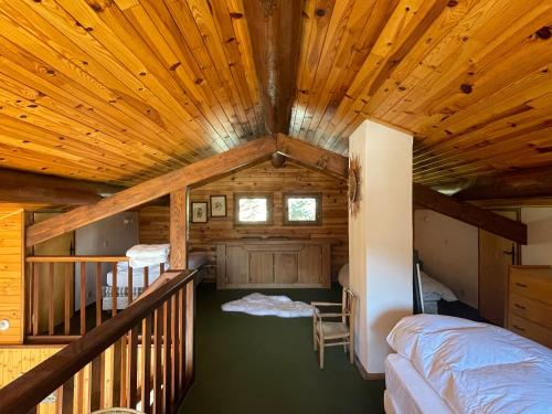 a log cabin with a bedroom and a balcony at South-facing Chalet With Views in Le Villard-Late