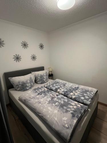 a bedroom with a bed with a gray comforter at Apartment O&V 2 in Waldshut-Tiengen