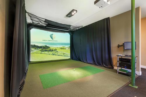 a bedroom with a view of a golf course through a window at Best Western Plus Plaza by the Green in Kent