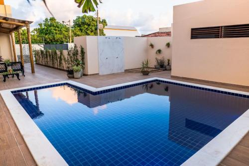 a swimming pool in the backyard of a house at Hotel Rochedo, Penedo - Alagoas in Penedo