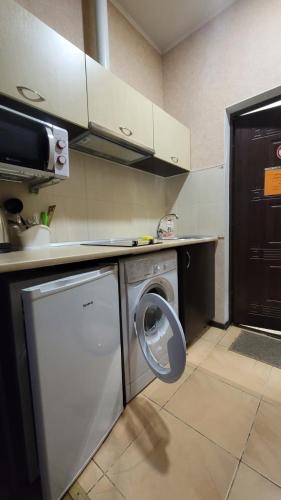 a kitchen with a washing machine and a dishwasher at Apartment in the city centr Bursatsky descent in Kharkiv