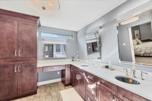 a bathroom with a sink and a mirror and a bed at 227 Goldstein in Punta Gorda