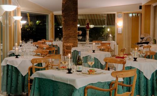 a dining room with white tables and chairs at Best Western Regina Elena in Santa Margherita Ligure