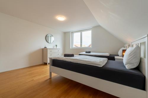 a bedroom with a bed and a window at Swiss Suites - Stusslingen in Lostorf