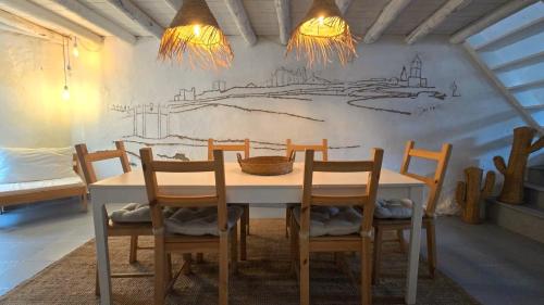 a dining room with a table and four chairs at Villa Oliva São Pedro in São Pedro do Corval