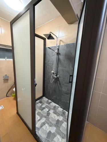 a shower with a glass door in a bathroom at OTAKS1 Waterside stunning 2b villa 80 metres from the beach with all amenities nearby & a large pool in Grand-Baie