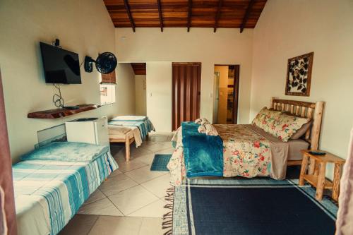 Postel nebo postele na pokoji v ubytování Pousada Recanto dos Pássaros