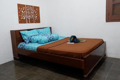 Ένα ή περισσότερα κρεβάτια σε δωμάτιο στο Omah Kuwitan, Traditional Java Home & Hospitality