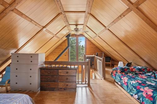 a attic bedroom with a bed and a desk at The Tiny Cozy Retreat in Saint-Just-de-Bretenières