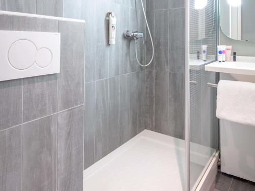 a shower with a glass door in a bathroom at ibis Brignoles Provence Verte in Brignoles