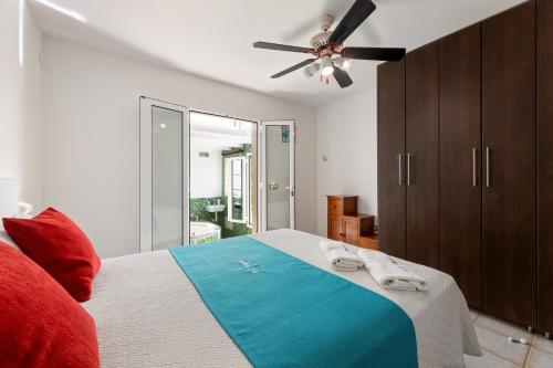 a bedroom with a bed and a ceiling fan at Serenity Villa Lanzarote by Beyond in San Bartolomé