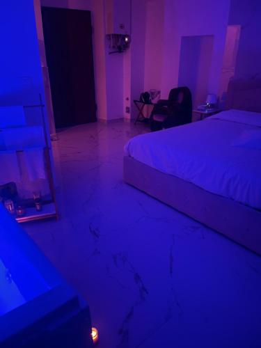 a dark room with a bed and a mirror at Nuvola Luxury suite in Turin