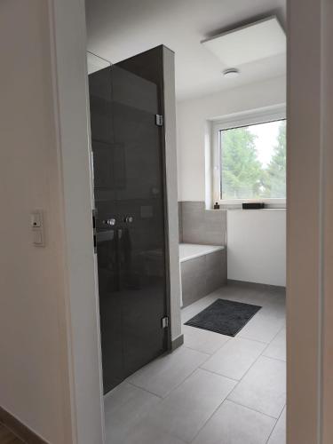 a kitchen with a black refrigerator in a room at Annas Ferienwohnung in Wallerfangen