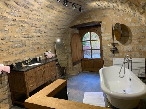 a bathroom with a sink and a bath tub at Manoir du Charme dans les Gorges du Tarn LOZERE in Quézac