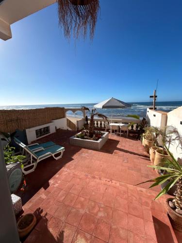 an outdoor patio with a view of the ocean at À Unique villa, 4 rooms, 5 beds , entire house, LEGZIRA Beach in Sidi Ifni