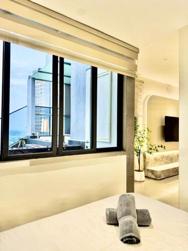 a bedroom with a bed with a large window at Jacuzzi with Starry Sky Bedroom-7pax in Malacca