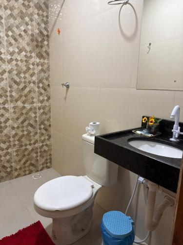 a bathroom with a toilet and a sink and a shower at Hotel Caribe de Alter - Alter do Chão in Santarém
