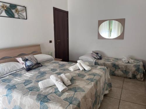 a bedroom with two beds with towels on them at Alice's House in Civitavecchia
