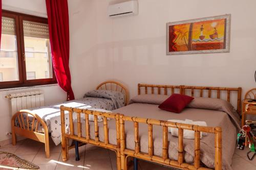 a bedroom with two beds and a window at B&B Lido Azzurro in Catanzaro Lido