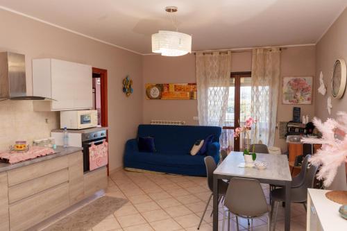 a kitchen and living room with a blue couch at B&B Lido Azzurro in Catanzaro Lido