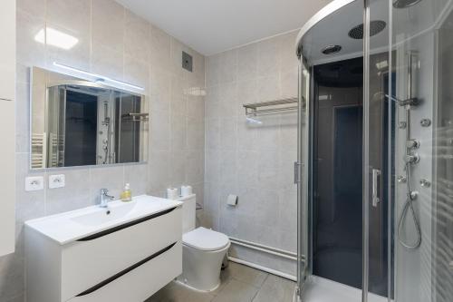 a bathroom with a toilet and a sink and a shower at Le petit Taison - Metz Hyper center in Metz