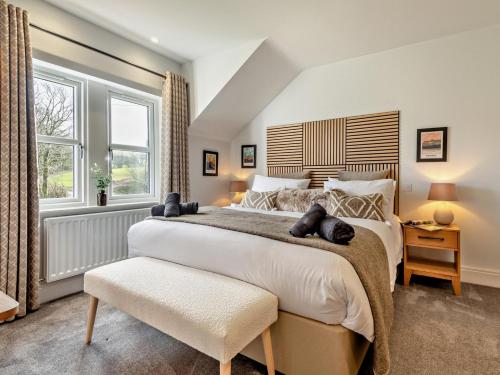 a bedroom with a large bed and a window at 3 Bed in Loweswater 94152 in Arlecdon