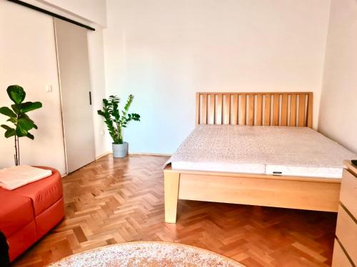 a bedroom with a bed and a potted plant at City-Centre appartment in Piešťany