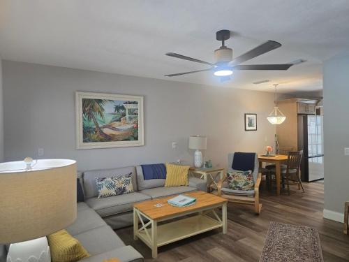 a living room with a couch and a ceiling fan at An Island Getaway at Palm Tree Villas in Holmes Beach
